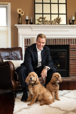 Realtor Matt Dejanovich with his dogs in his Ann Arbor home